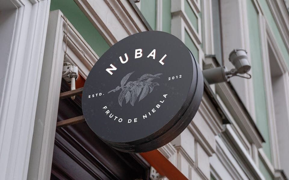 A round Nubal sign on the coffee shop façade